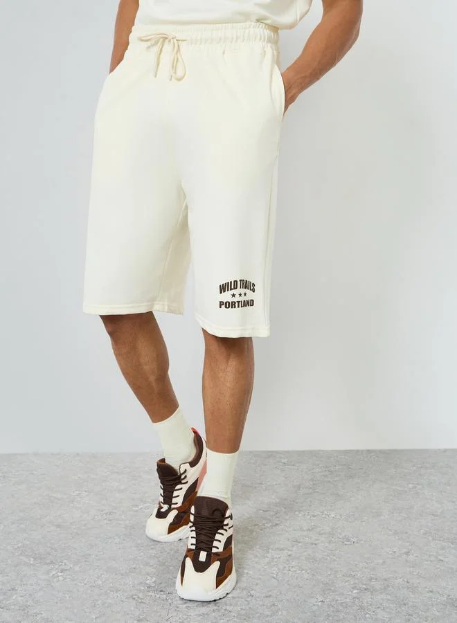 Styli  Men Cream Minimal Print Oversized T-Shirt and Shorts Co-Ords for Men | Best Price UAE